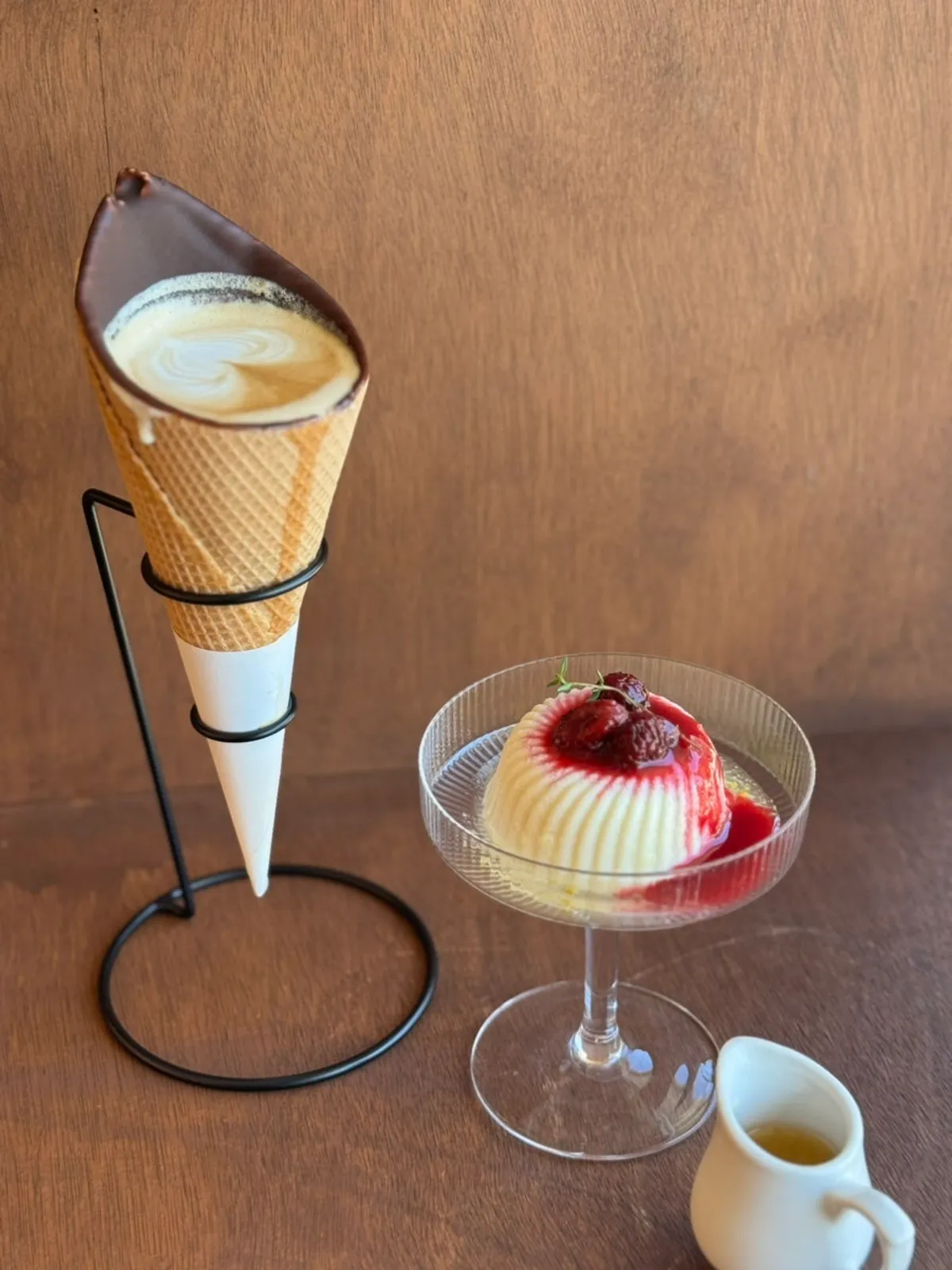 Cone choco latte and tofu pudding on a bar table by the window