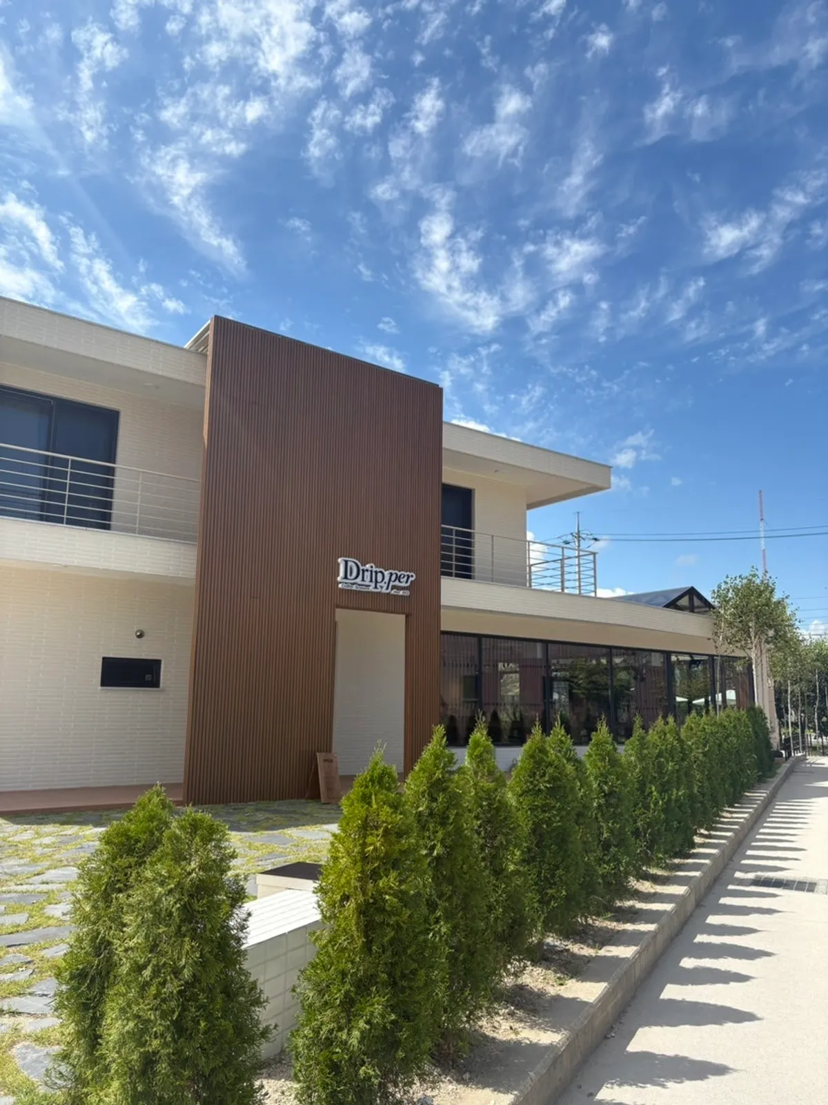 Entrance and wood-toned building of Coffee Dripper