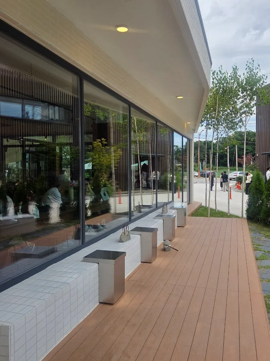 Outdoor seating with white tile benches and silver tables