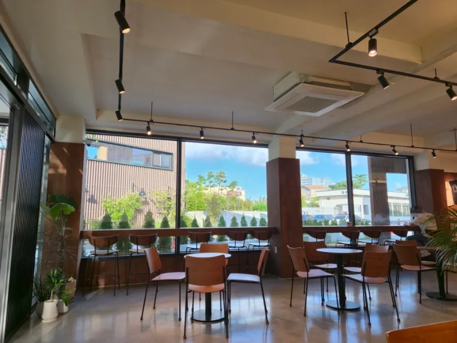 Café interior with natural light from floor-to-ceiling windows