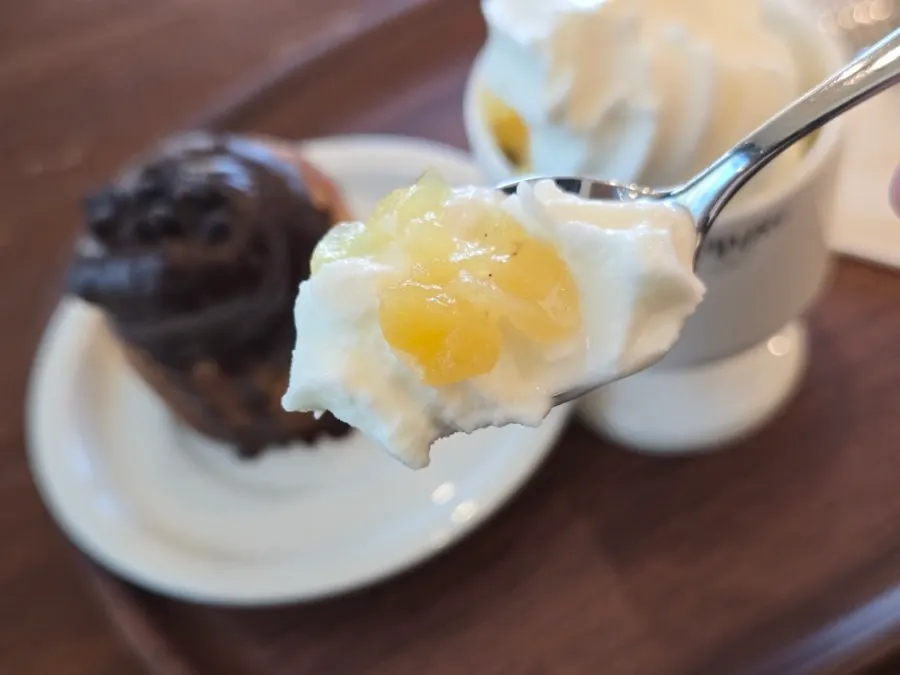 A bite of soft serve topped with fruit pieces