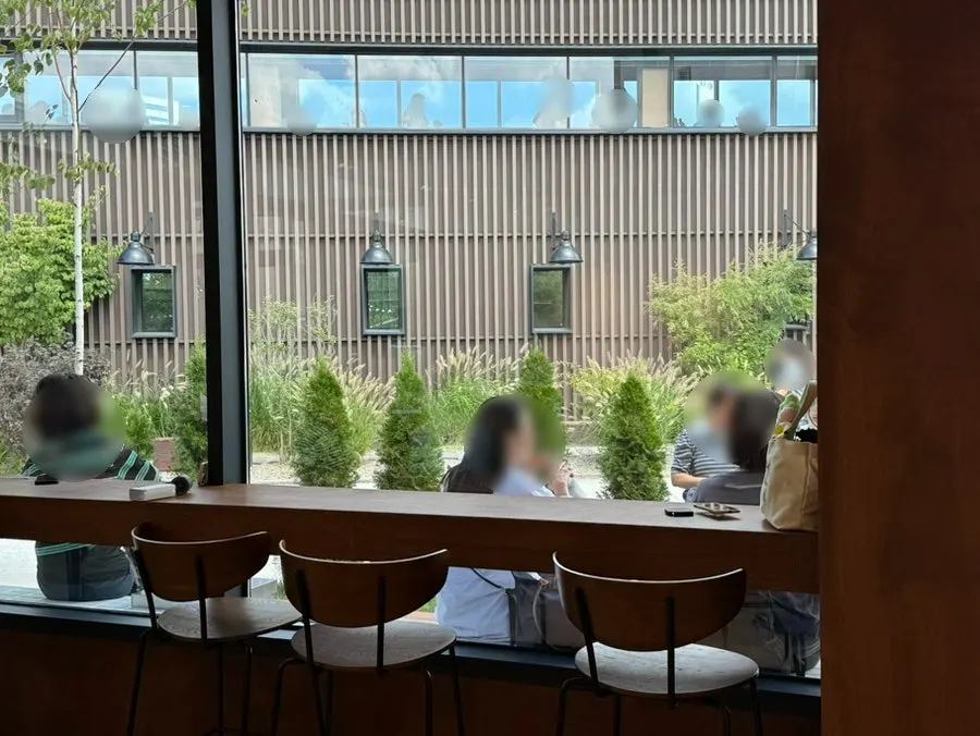 Café seating surrounded by green plants