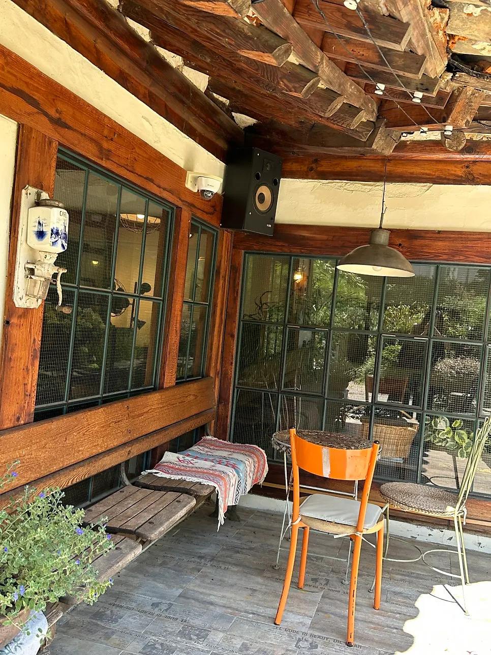 Outdoor tables at Cafe Giwa surrounded by green trees