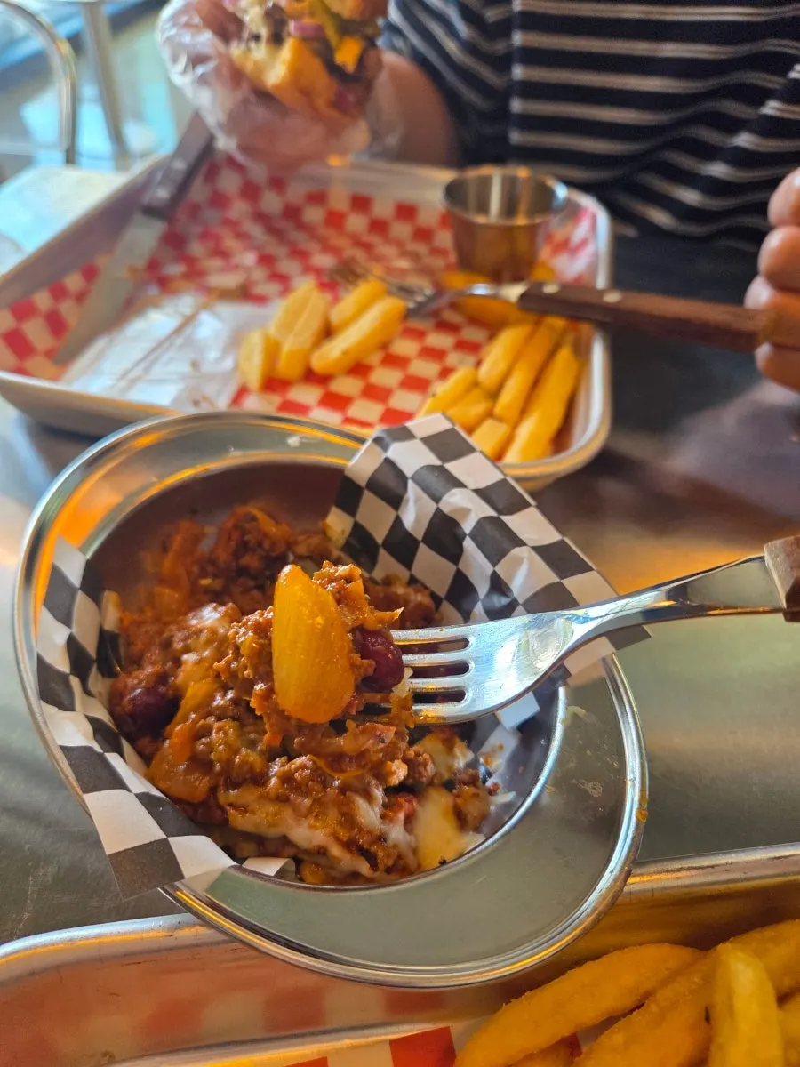 Chili beans topped with ground meat and cheese