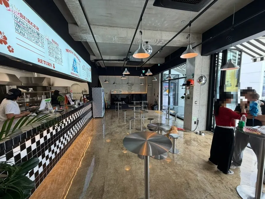 Moana Burger's dining area with the open kitchen visible