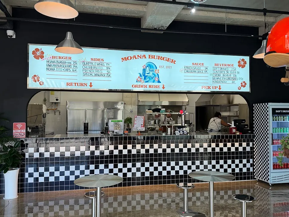 Moana Burger menu board matching the restaurant's vibe