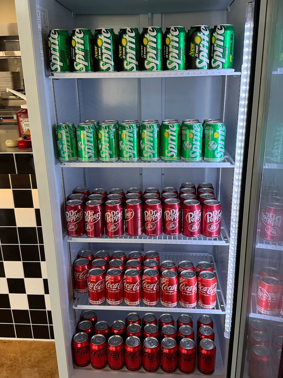 Fridge full of various drinks and bottled beers