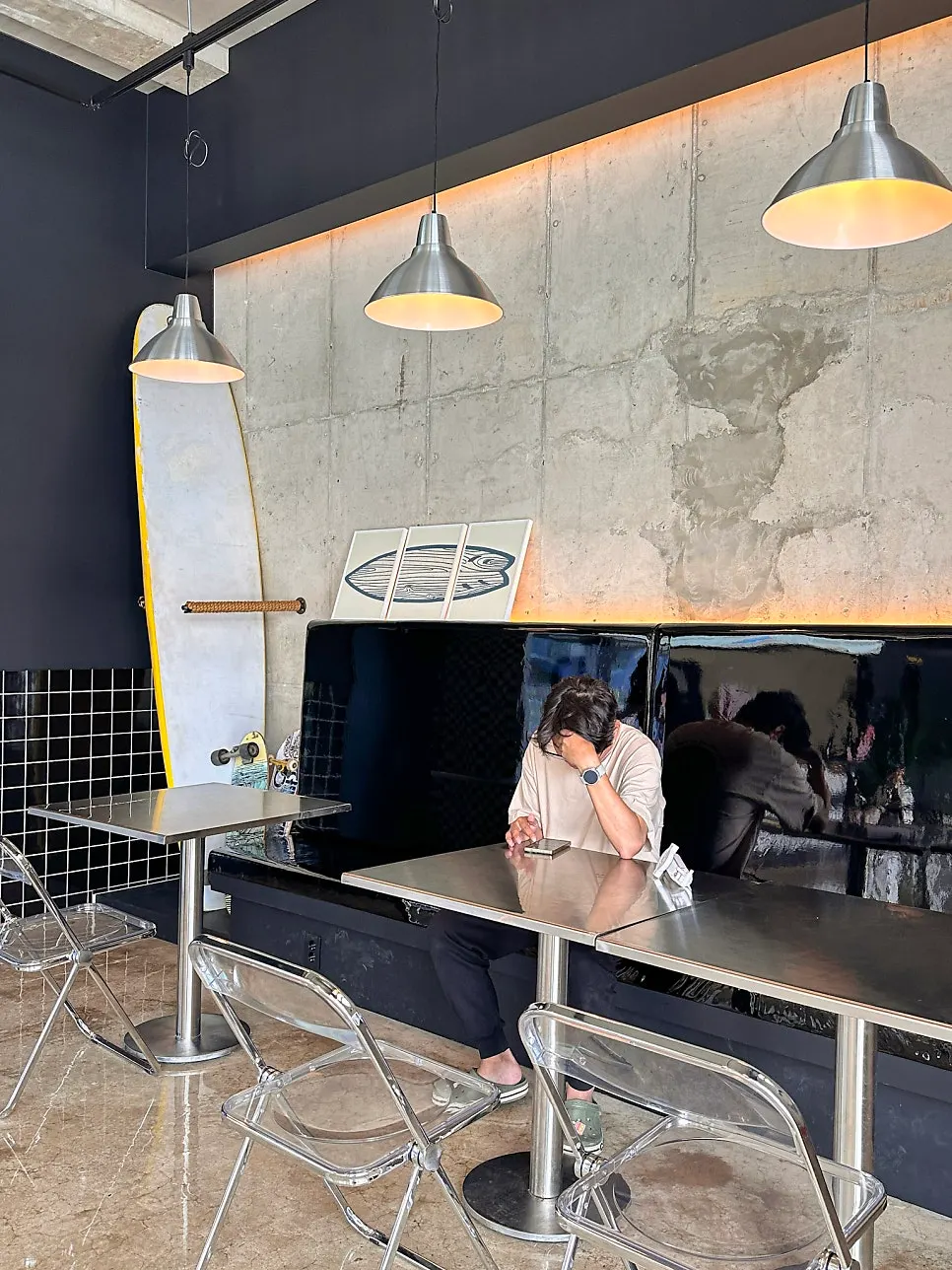 Interior of Moana Burger decorated with surfboards and plants