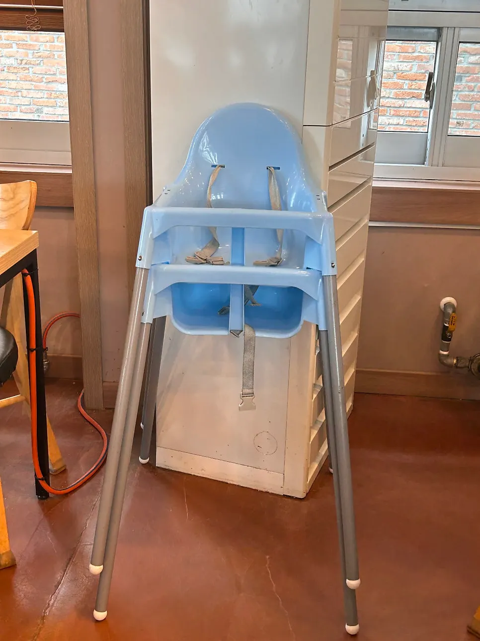 Table set with a baby chair and baby fork and spoon