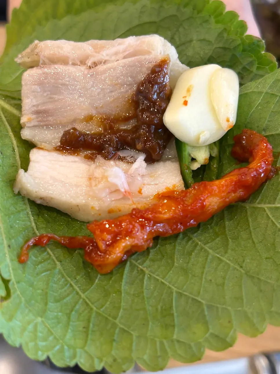 Homemade ssamjang with a wrap of boiled pork