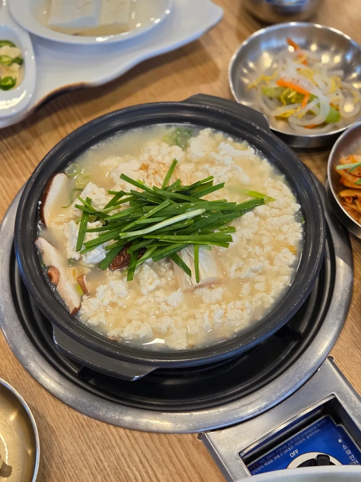 Chodang Myeongpum table with sundubu jjigae, tofu samhap, and braised pollock
