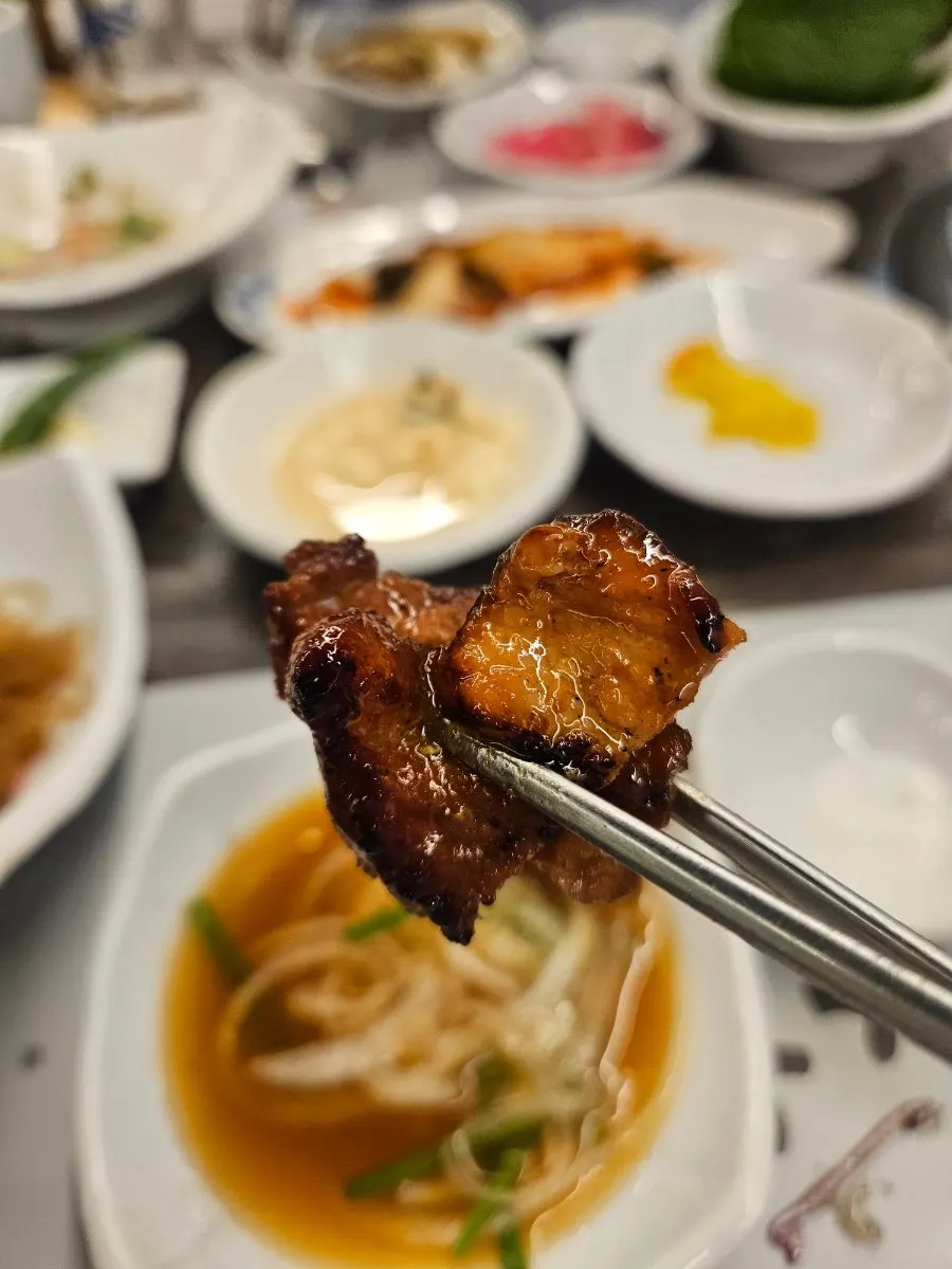 A piece of pork galbi wrapped in lettuce