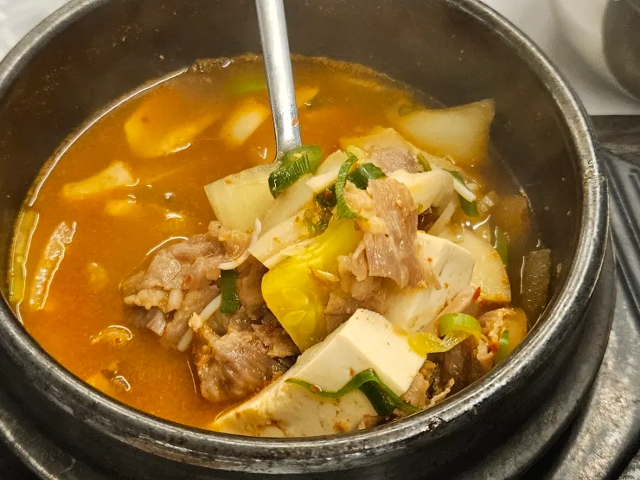 Bowl of bibim naengmyeon served with broth