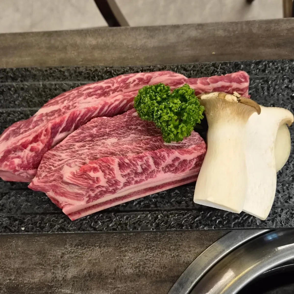 Signature shot of the grilled woo-dae galbi at Chodang Uga