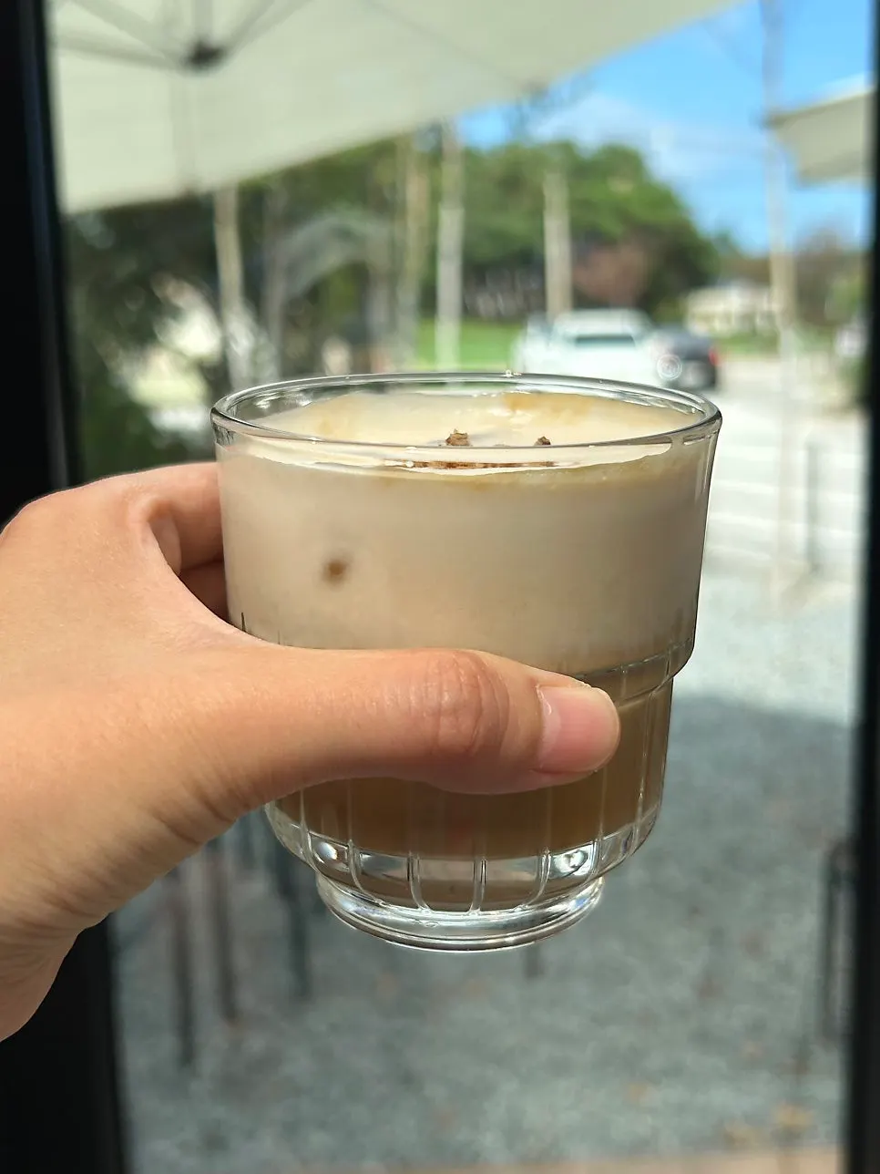 A cup of dripper latte with soft milk foam