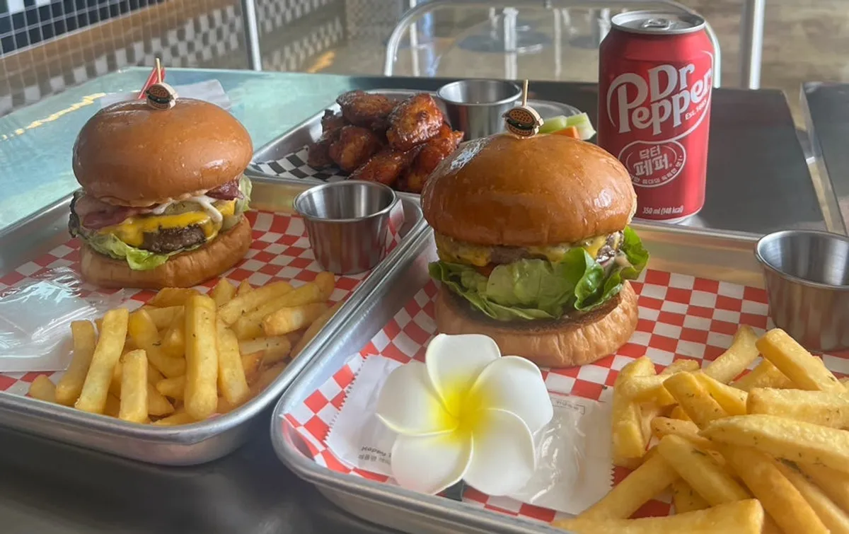 Table spread of handmade burgers at Moana Burger in Chodang-dong, Gangneung