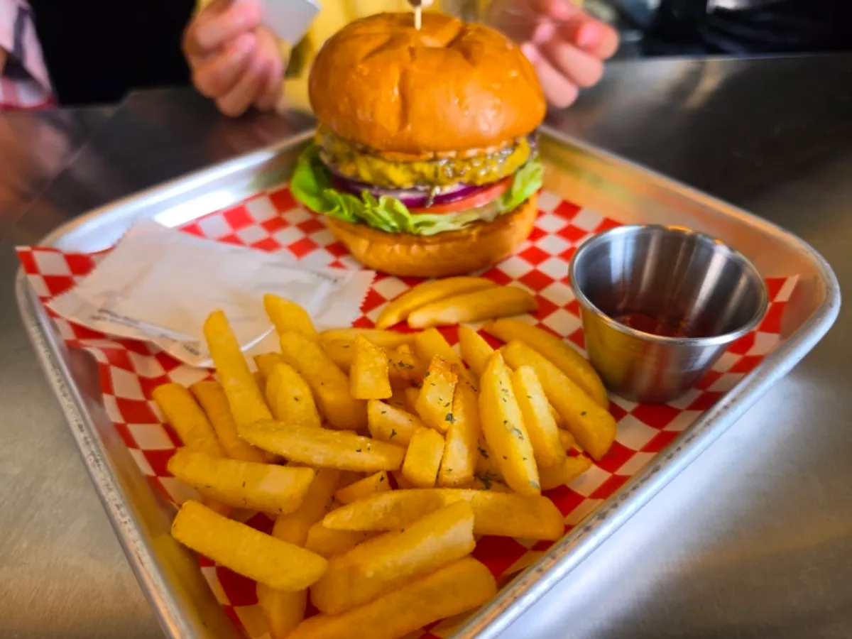Moana Burger plated together with a side of fries