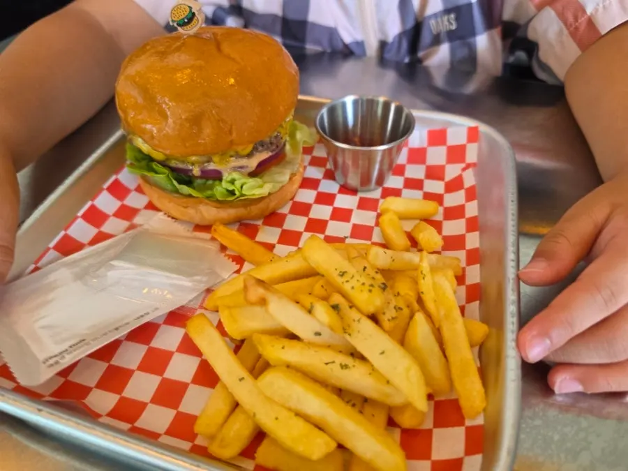 Cross-section of the Moana Burger showing patty, cheese, and vegetables