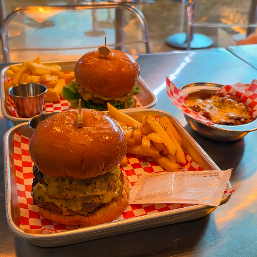 Table spread of Moana Burger, Moana Double Burger and chili beans