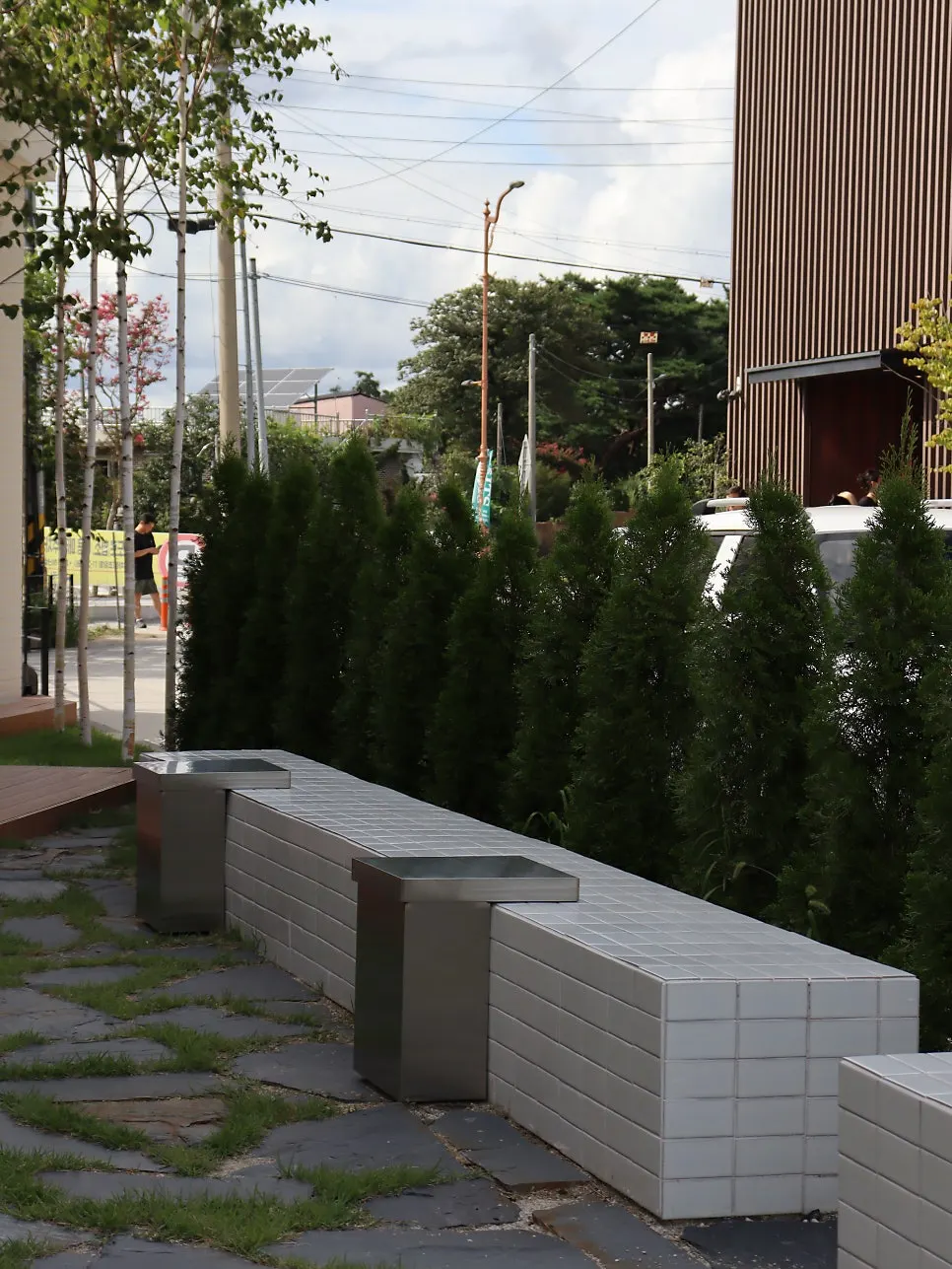 Outdoor café tables surrounded by green scenery