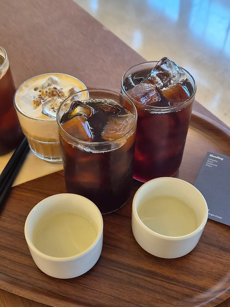Iced americano next to the Dripper House Blend