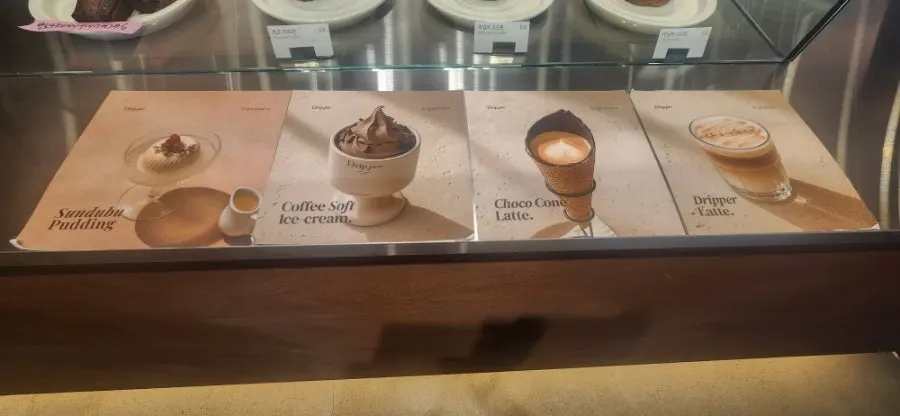 Coffee Dripper menu board listing signature and drip coffee items
