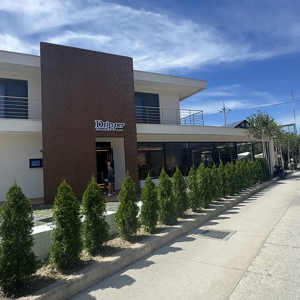 Wood-toned exterior and entrance with the Dripper logo