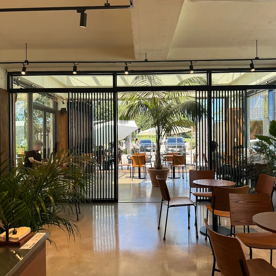 Café interior mixing wood tones and stainless steel