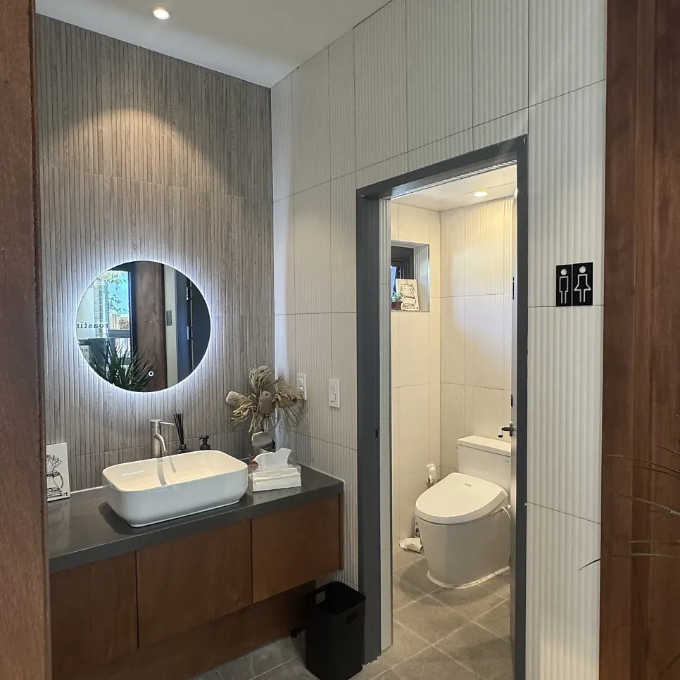 Café bathroom done in wood and gray tones