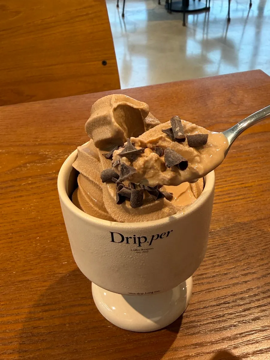 Close-up of coffee soft serve topped with chocolate chips
