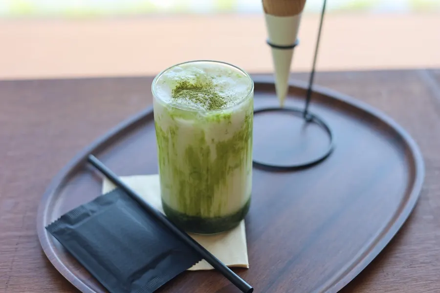 A glass of iced pine needle matcha latte