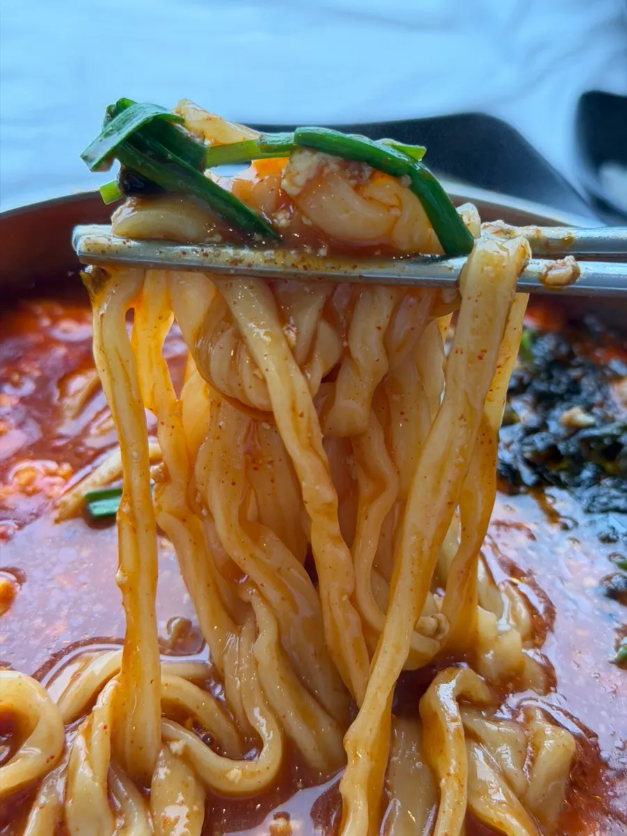 Spicy sundubu kalguksu with a fiery broth