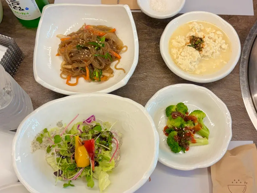 Table set with various side dishes at the meat restaurant