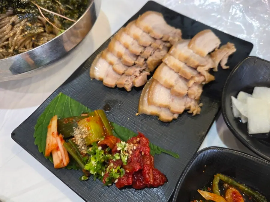 Full table spread of makguksu and buckwheat gimbap