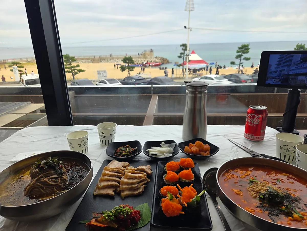Two-person set spread with the sea as backdrop