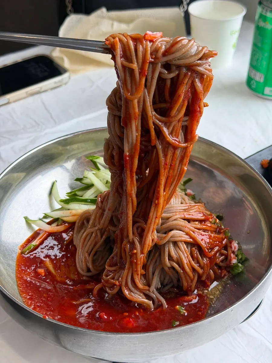 Close-up of spicy bibim makguksu sauce and buckwheat noodles
