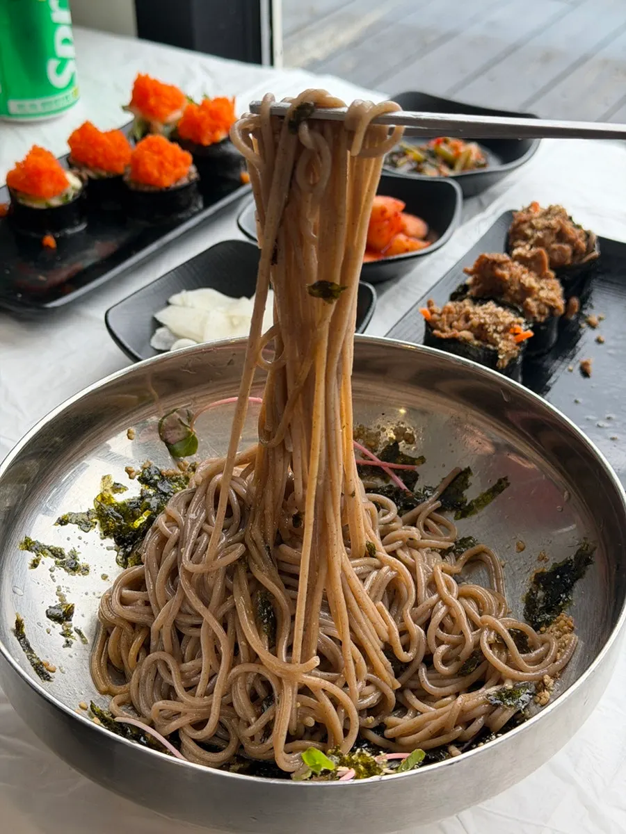 Close-up of perilla oil makguksu noodles and toppings