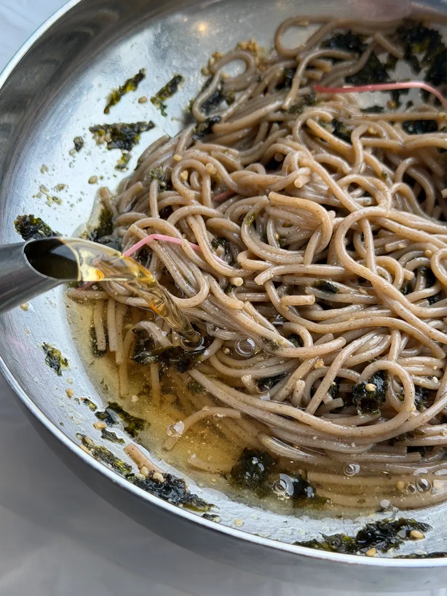 Perilla oil makguksu mixed with a splash of broth added in