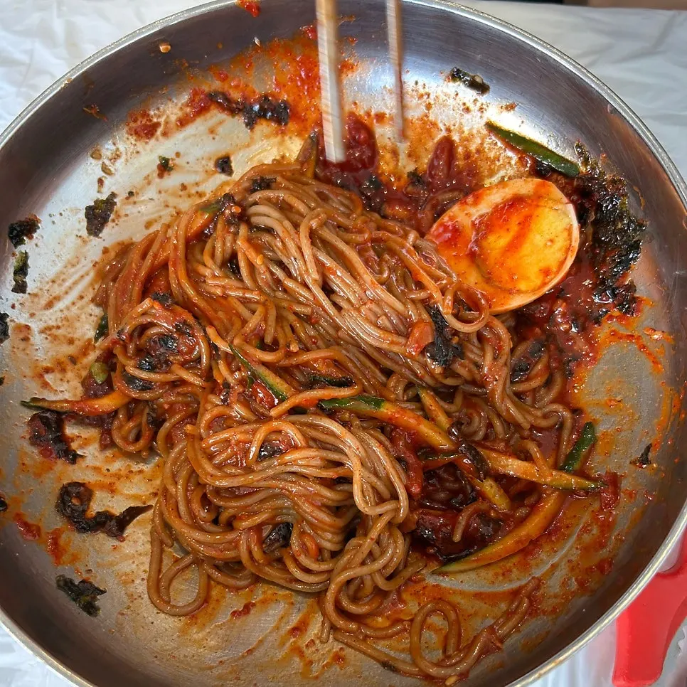 Bibim makguksu topped with fermented pollock