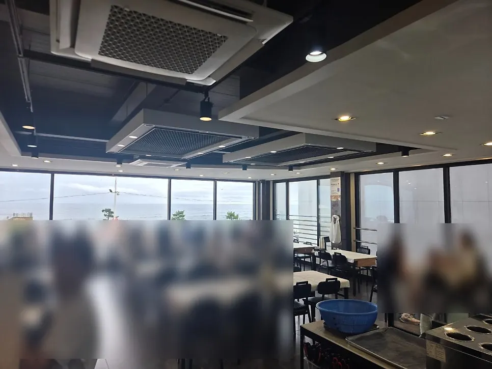 Interior with floor-to-ceiling windows overlooking Gangmun Beach