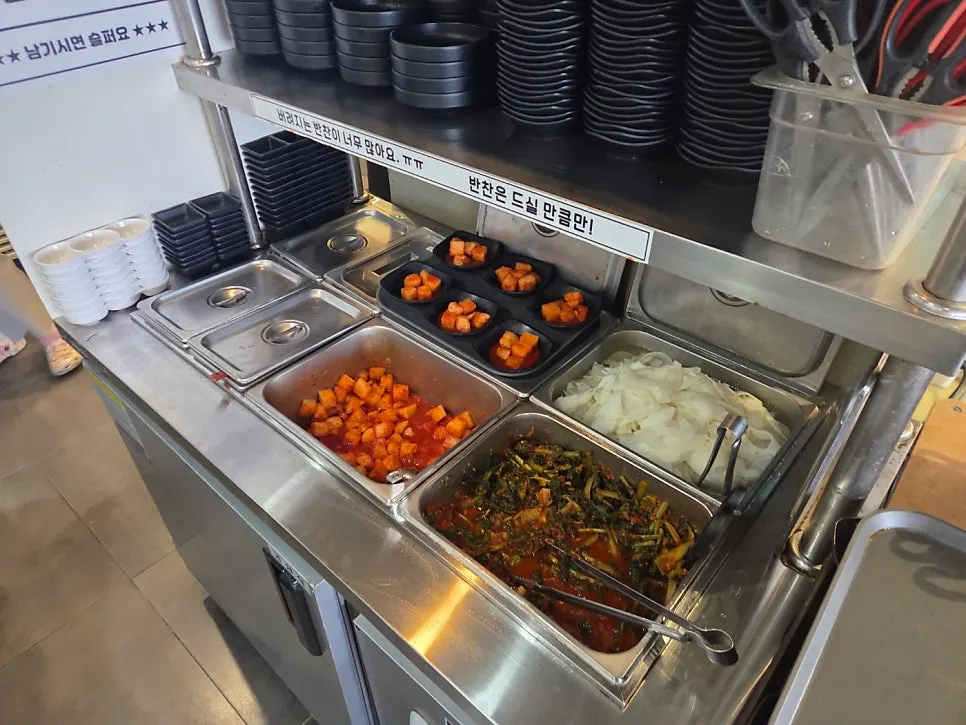 Self-serve station with side dishes and utensils