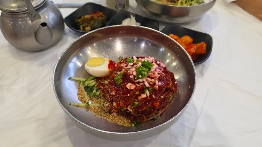 Bibim makguksu served with a side of broth