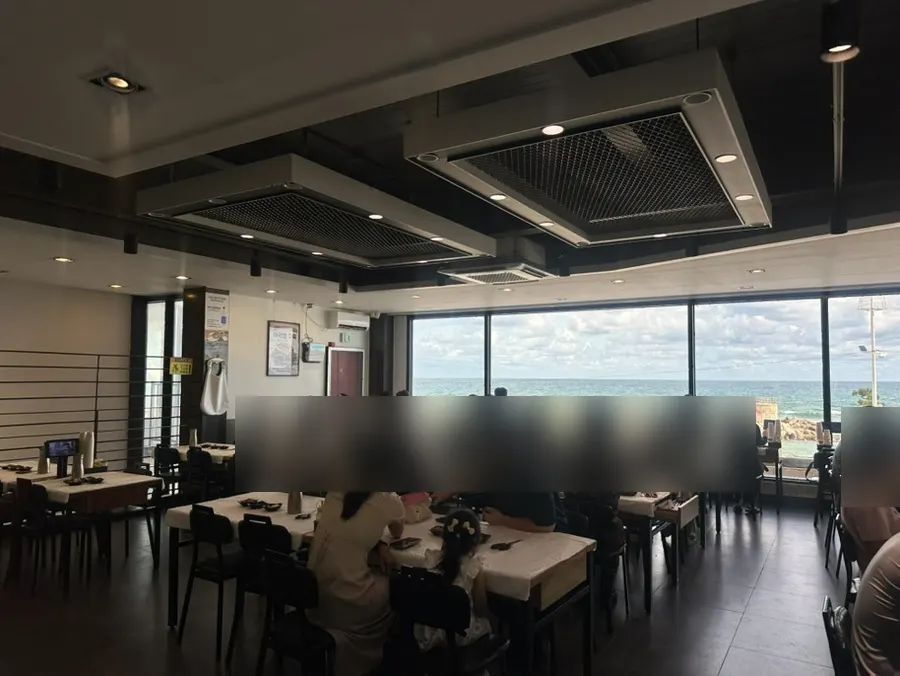 Second-floor hall seating with floor-to-ceiling ocean view