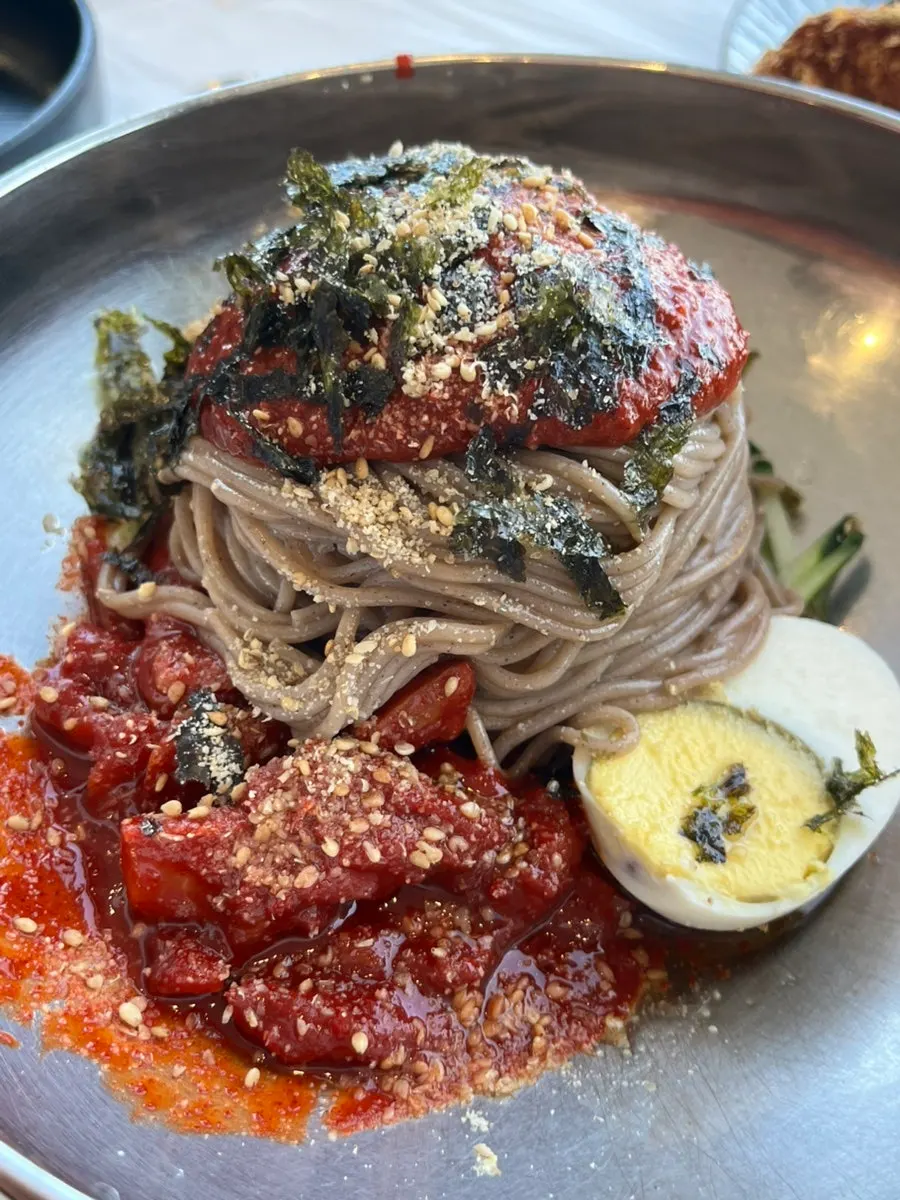 Mul-makguksu noodles lifted up with chopsticks