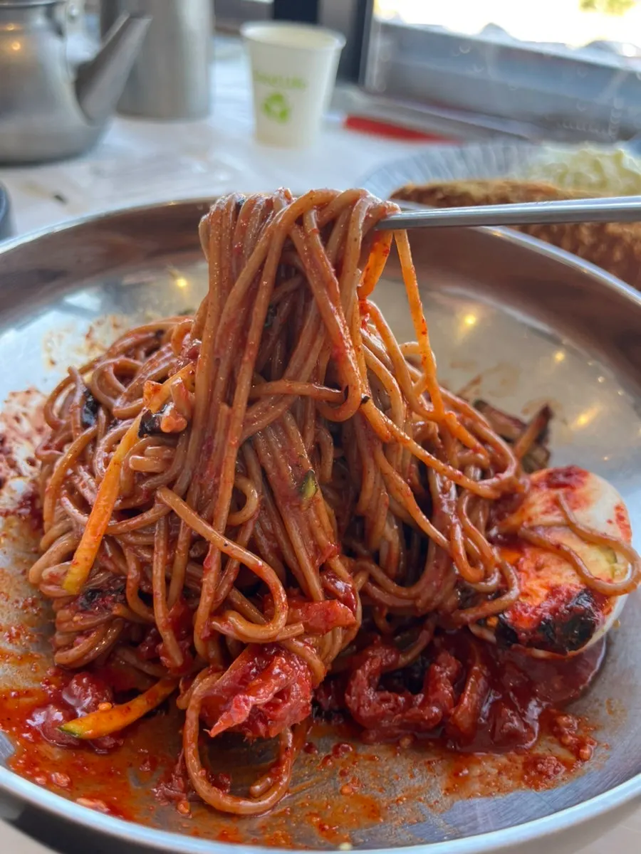 Bibim makguksu topped with pollock jeotgal