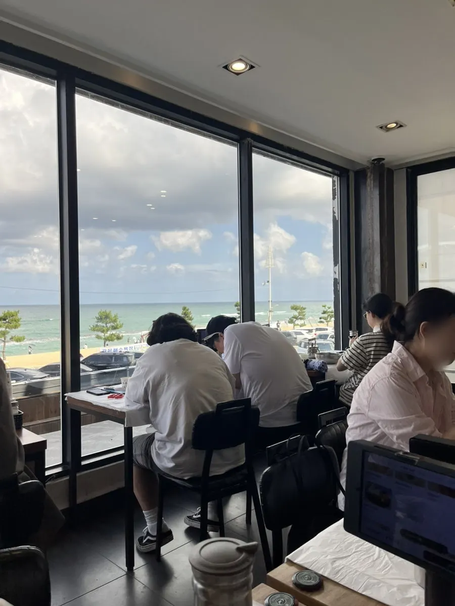 Floor-to-ceiling ocean view on the 2nd floor of Gossi's Donghae Makguksu