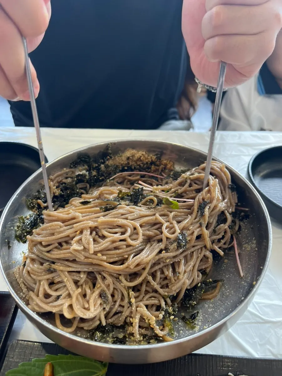 House-made buckwheat noodles lifted with chopsticks