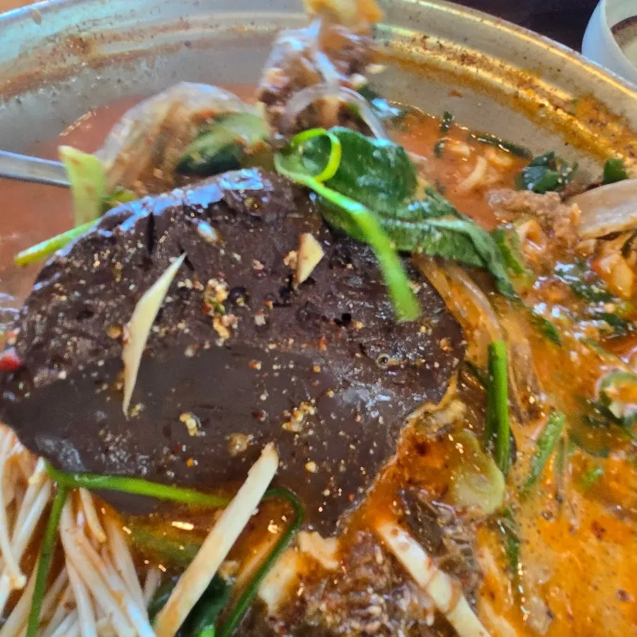 Beef tripe hot pot topped with vegetables