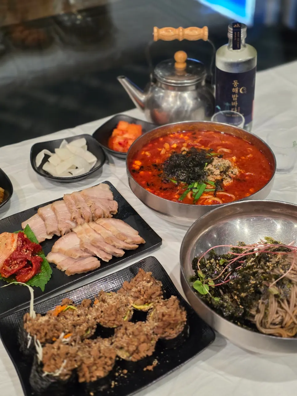 Spicy sundubu jang kalguksu with a deep red broth