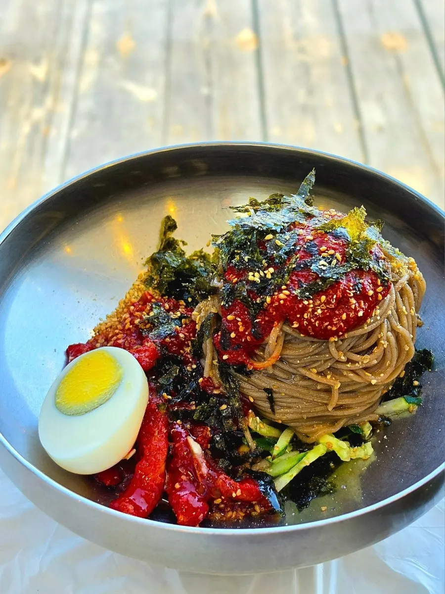 Table set with makguksu and side dishes